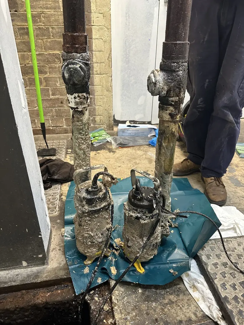 Dual grease trap pumps showing fat, oil and grease buildup during a service visit