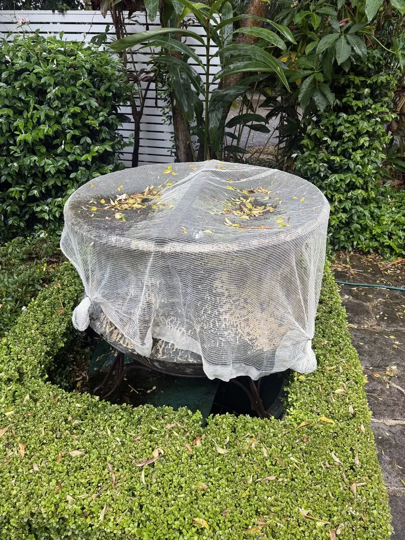 A hard-access pump pit located beneath a garden pond at a Sydney property