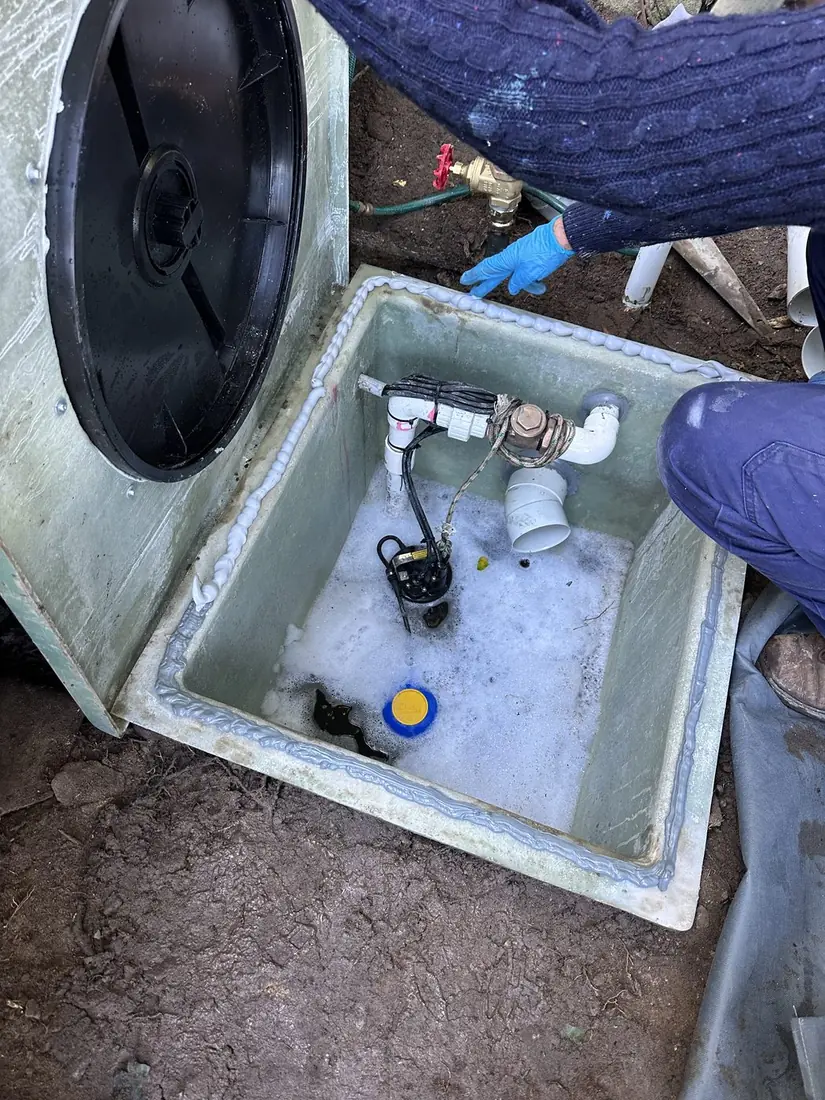 A new custom fibreglass sewer pump pit installed at a Sydney property, replacing an old cracked fibre-cement tank