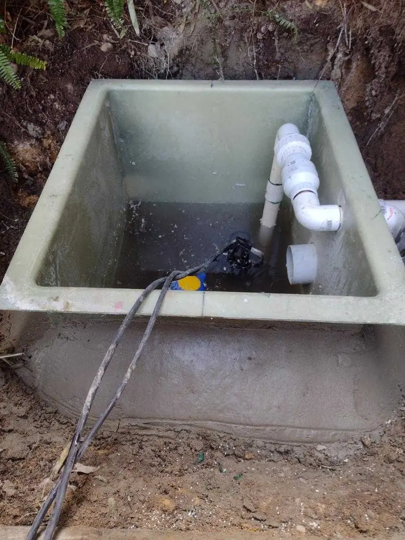 New fibreglass pump pit installed on a fresh concrete bed with pipework on a Sydney home build
