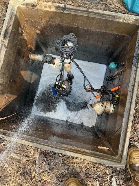 Pump pit during service with walls flushed and water flowing through the pit during clean-out