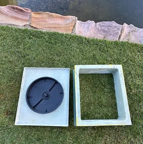 A gas-tight pump pit lid and frame laid out before fitting at a Sydney property
