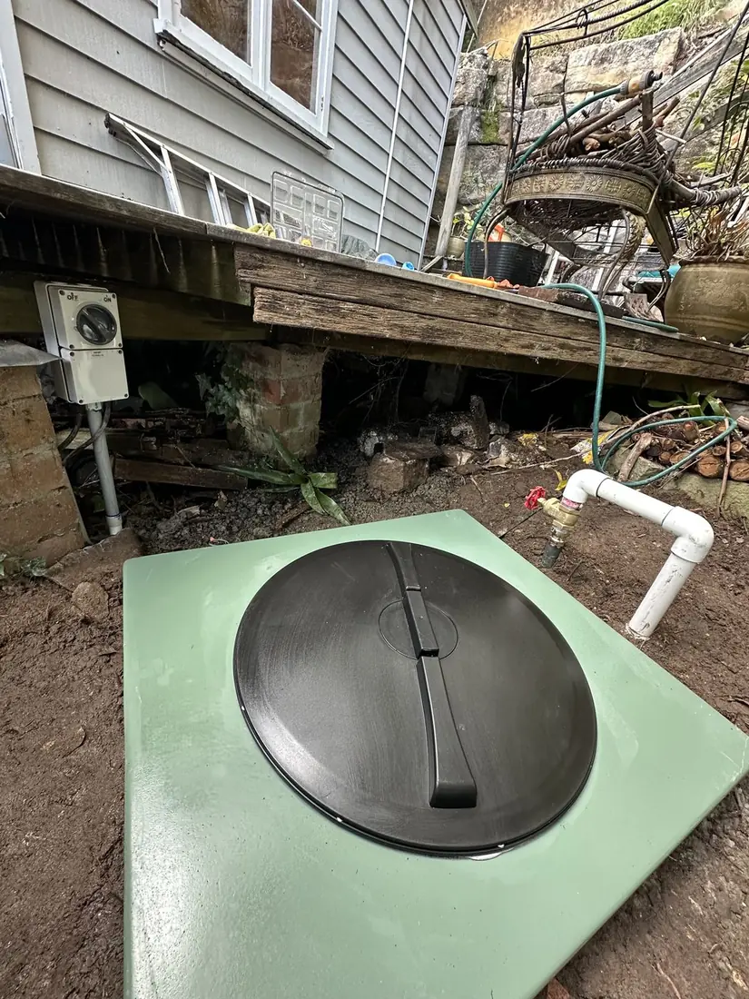 A completed sewer pump pit installation with isolator at a Sydney home