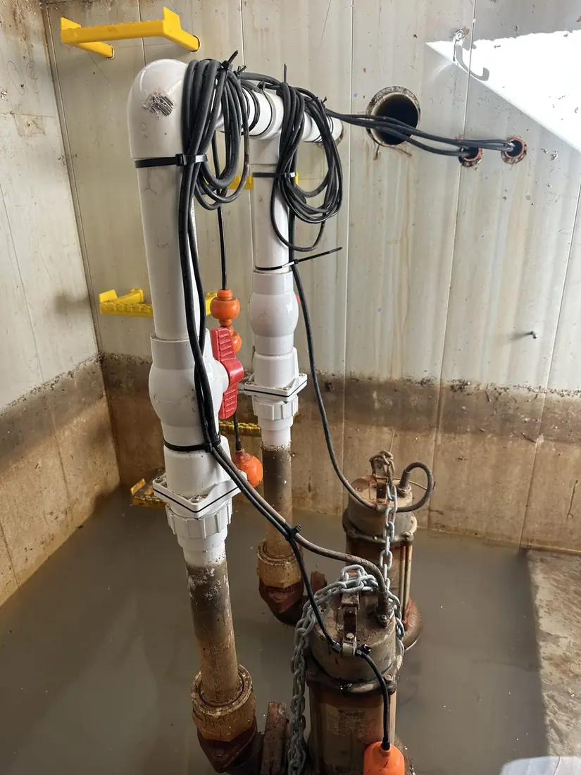 The same pump pit with the cabling tied back clear of the water and the float repositioned to swing freely